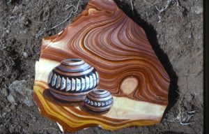 Native American pottery is painted on a rhyolite gemstone approximately 4"x5" in 1983